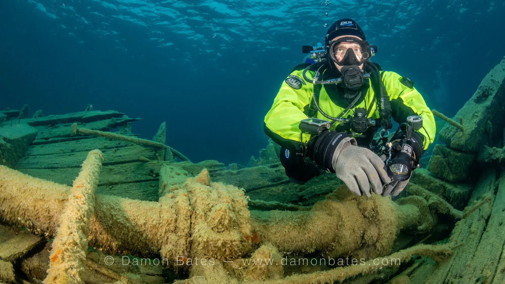 Underwater photographer examining the anchor chain of the Wetmore wreck, Lake Huron, Tobermory, Ontario — underwater photograph by Damon Bates