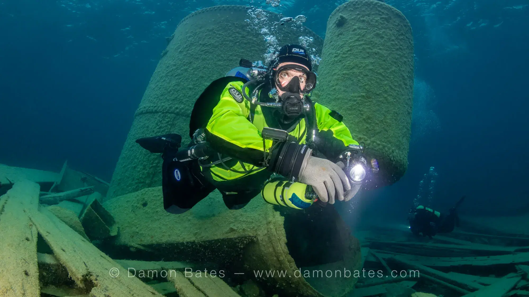 Underwater photographer with camera rig beside the preserved bollards of the Wetmore wreck, Lake Huron, Tobermory, Ontario — underwater photograph by Damon Bates