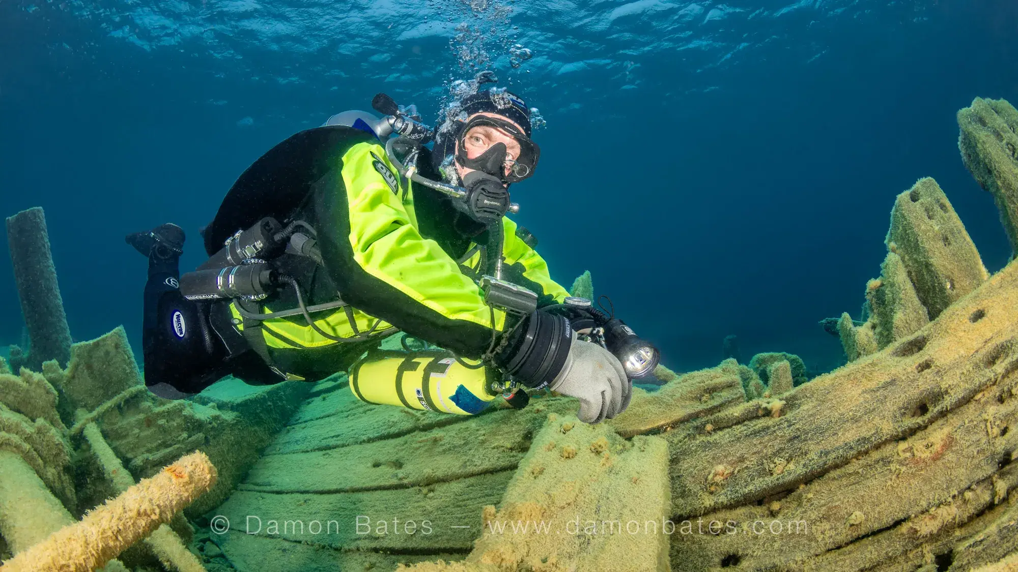 Underwater photographer examining deck hardware on the Wetmore wreck, Lake Huron, Tobermory, Ontario — underwater photograph by Damon Bates