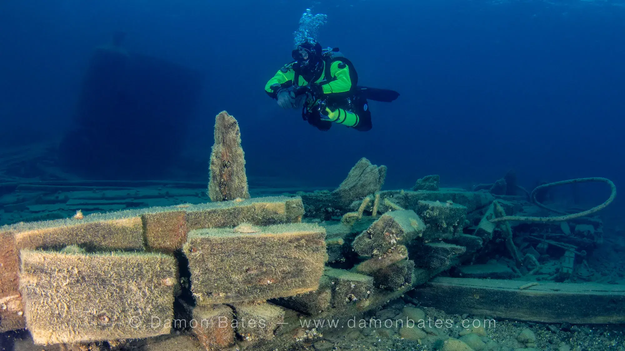 Scuba diver hovering over the wooden hull remains of the Wetmore wreck, Lake Huron, Tobermory, Ontario — underwater photograph by Damon Bates