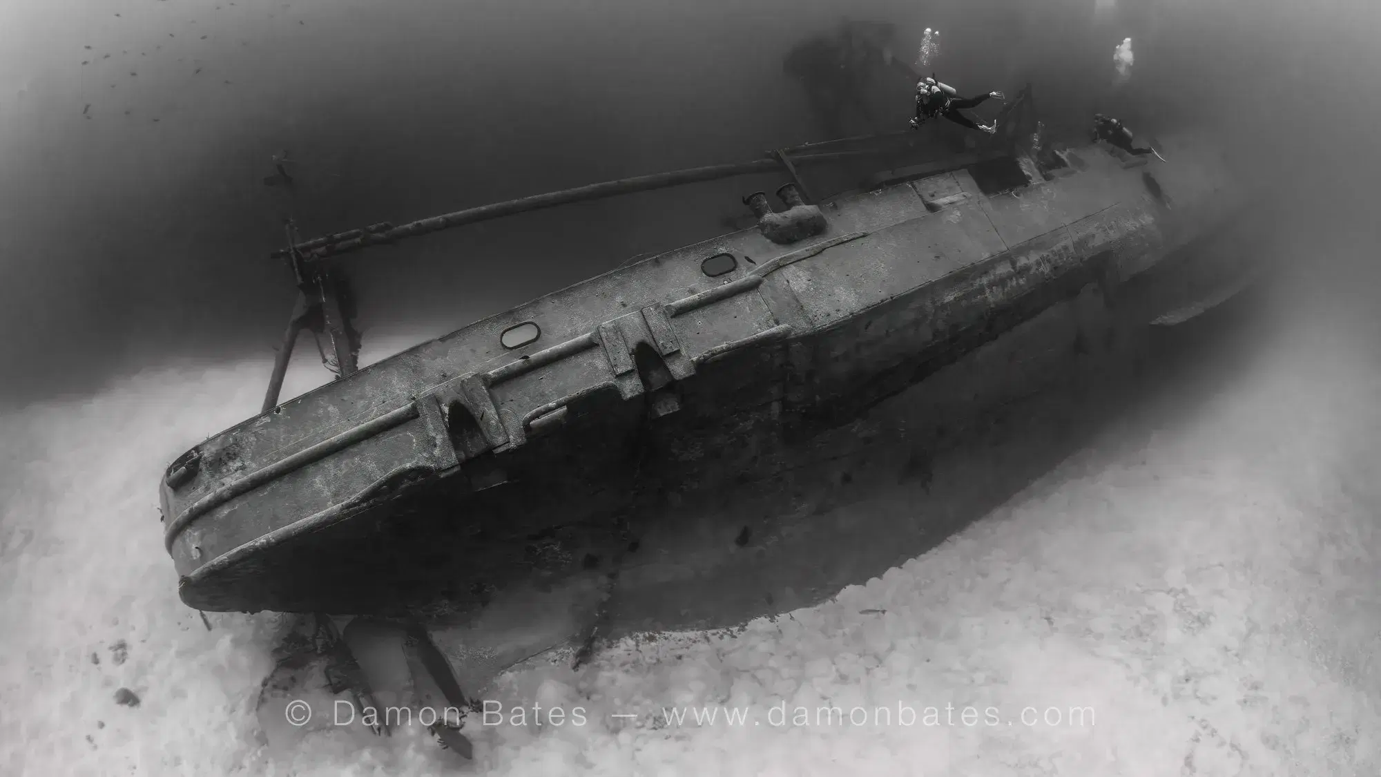 Overhead view of the USS Kittiwake lying on the sandy seafloor, Grand Cayman, 2025 — black and white — underwater photograph by Damon Bates