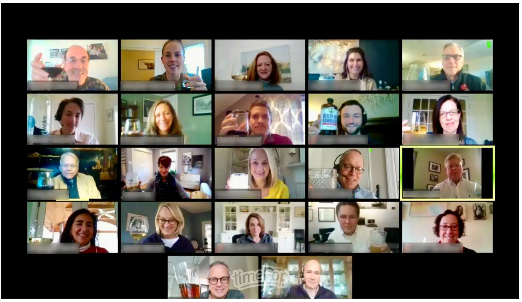 Large virtual team meeting on video call with 20+ participants visible in a grid of home office windows — leading remotely before Slack and Zoom